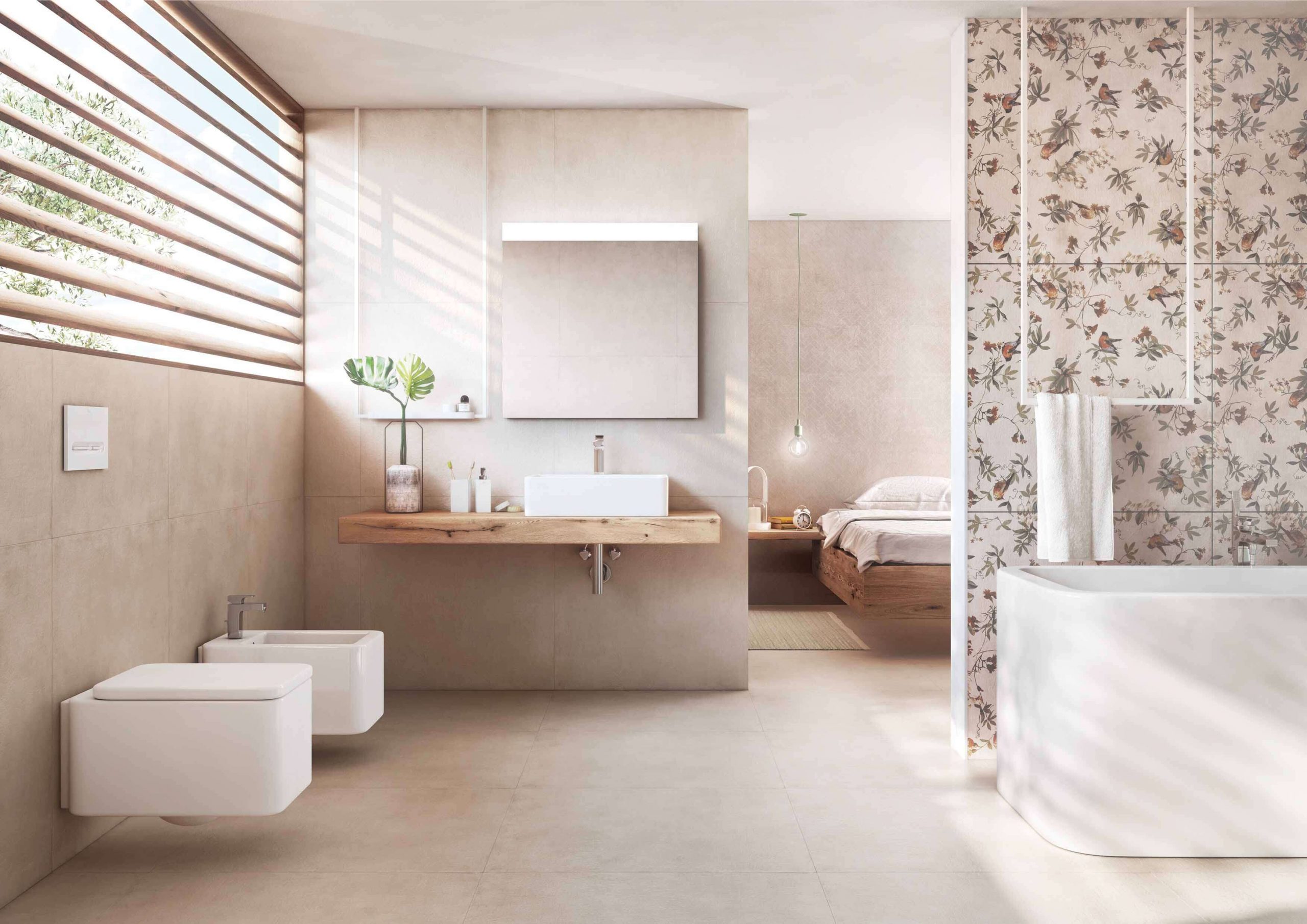 Jasna, przytulna łazienka wyłożona płytkami imitującymi beton z dekoracyjną ścianą, białą wanną, wiszącą półką drewnianą z umywalką nablatową, lustrem oraz wiszącą miską WC i bidetem