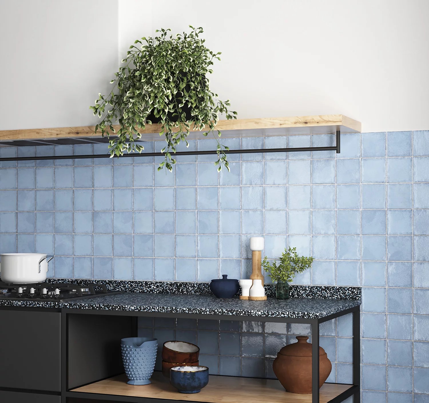 Kuchnia ze ścianą wyłożoną błękitnymi cegiełkami w połysku z czarną szafką i wiszącą półką z kwiatem