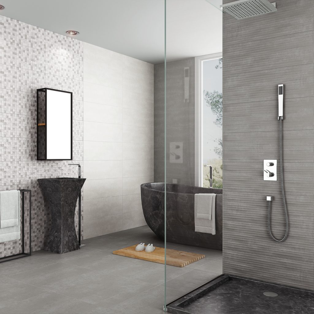 Łazienka wyłożona szarymi płytkami z kabiną prysznicową, ciemną, kamienną wanną i umywalką wolnostojącą oraz lustrem