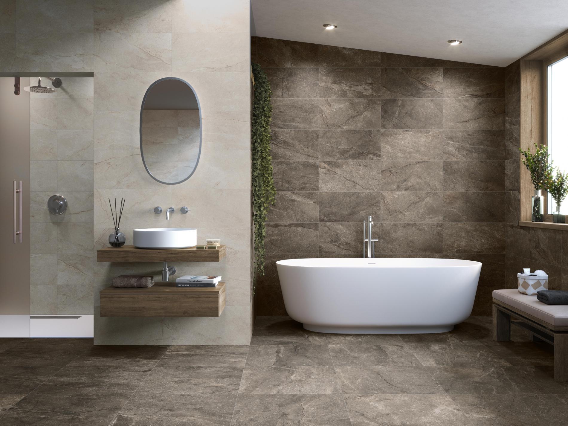 Łazienka wyłożona brązowymi i beżowymi płytkami imitującymi kamień z kabiną prysznicową, wanną, umywalką nablatową i owalnym lustrem