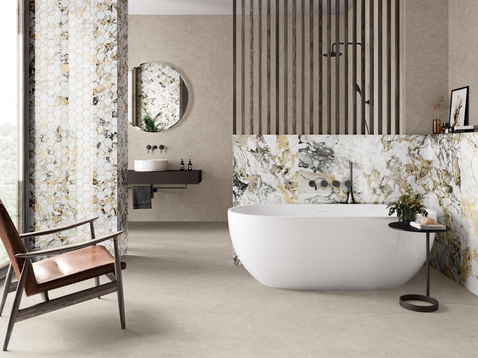 Łazienka z płytkami imitującymi beton i marmur, z wanną wolnostojącą, umywalką nablatową i okrągłym lustrem