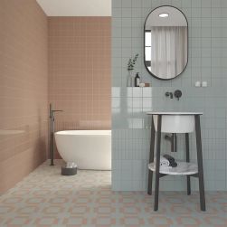 Łazienka wyłożona cegiełkami z kolekcji Bits, z umywalką stojącą, owalnym lustrem i wanną wolnostojącą