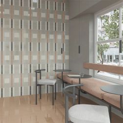 Restauracja wyłożona kolorowymi cegiełkami z kolekcji Bits, z ławą pod oknem, małymi, okrągłymi stolikami i krzesłami