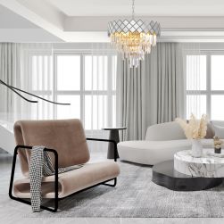 Elegancki pokój z oryginalnym fotelem, jasną kanapą, marmurowym stolikiem i srebrnym żyrandolem Carisma Chrome