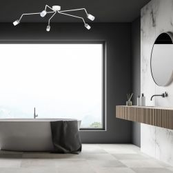 Łazienka z dużym oknem, wanną wolnostojącą, wiszącą półką z umywalką, okrągłym lustrem i białą lampą sufitową Joker White