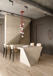 Minimalistyczna jadalnia z oryginalnym stołem i ścianą wyłożonymi płytkami imitującymi kamień z kolekcji Ego Sabbia, z czterema krzesłami i lampą wiszącą