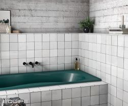 Minimalistyczna łazienka z zabudowaną zieloną wanną, czarną baterią podtynkową, ozdobami i cegiełkami ściennymi Artisan White