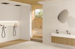 Łazienka wyłożona jasnymi płytkami imitującymi kamień MaPierre Ancienne Blanc ze strefą prysznicową, wiszącą szafką z umywalką, lustrami i wejściem do sauny