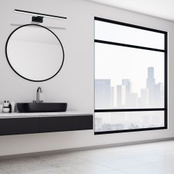 Minimalistyczna łazienka z czarną półką z umywalką nablatową, okrągłym lustrem i kinkietem Shine