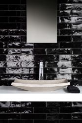 Ściana w łazience z białym blatem i umywalką nablatową z baterią stojącą i prostokątnym lustrem oraz czarnymi cegiełkami z kolekcji Poitiers