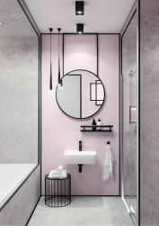 różowa łazienka z czarnymi elementami, czarne baterie, czarna bateria umywalkowa Hiacynt, duże okrągłe lustro, biały ręcznik na czarnym haczyku, czarna półka obok umywalki, duża kabina prysznicowa