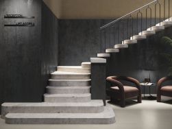 Hotel ze ścianami wyłożonymi czarnymi płytkami imitującymi metal Odyssey Nero ze schodami, dwoma fotelami i małym stoliczkiem