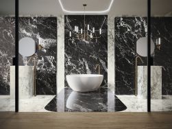 Elegancka łazienka wyłożona czarnymi płytkami imitującymi marmur Black Hispania z białą wanną wolnostojącą, dwiema stojącymi umywalkami i dwoma okrągłymi lustrami