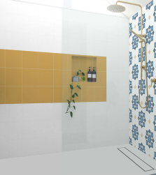 Prysznic typu walk-in, złota armatura, ściana przy baterii wyłożona dekoracyjnymi płytkami, druga ściana w części wyłożona żółtymi płytkami, podłoga i pozostała część ściany wyłożone Element Blanco 25x25 płytka bazowa