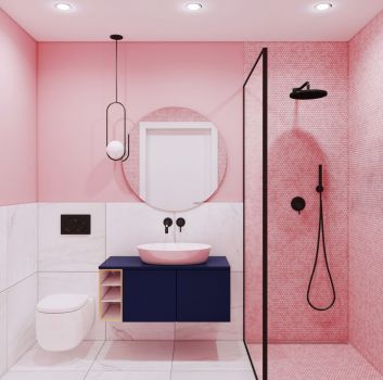 Różowo-biała łazienka z czarnym prysznicem, granatową szafką z umywalką nablatową oraz toaletą